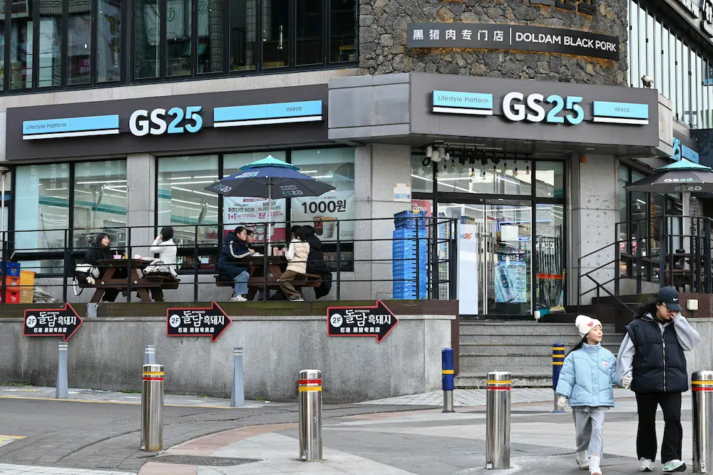 eating quick meals in front of korean convenience store gs25